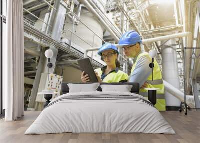 Industrial engineers working in recycling plant with tablet Wall mural