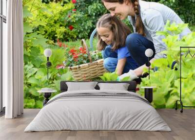 Little girl helping her mother to do gardening Wall mural