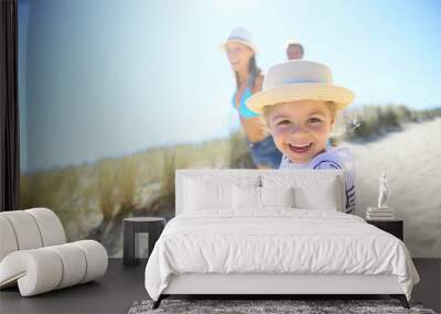 Little girl pulling parents' arms to run to the beach Wall mural