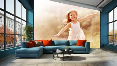 Little girl running in country field in summer Wall mural