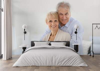 Loving senior couple looking at camera Wall mural