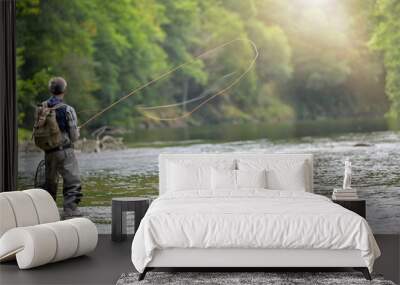 Man fly fishing in the summer in a beautiful river with clear water Wall mural