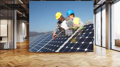 Man showing solar panels technology to student girl Wall mural