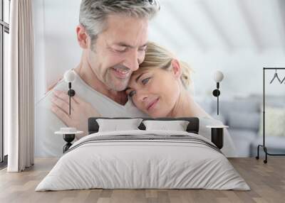 Mature couple embracing with love and tenderness Wall mural