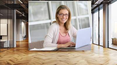 Middle-aged woman working from home on laptop Wall mural