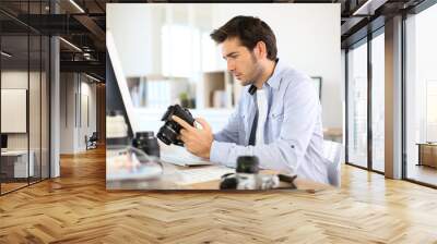 photographer in office working on desktop computer Wall mural