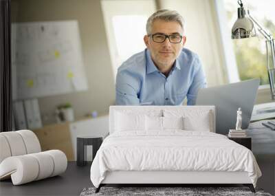 Portrait of architect looking at camera in office Wall mural