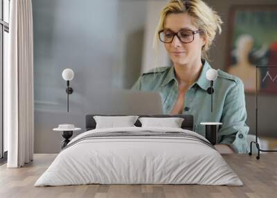 portrait of blond woman working from home on laptop computer Wall mural