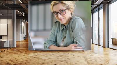 portrait of blond woman working from home on laptop computer Wall mural