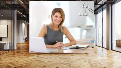 portrait of businesswoman working on laptop Wall mural