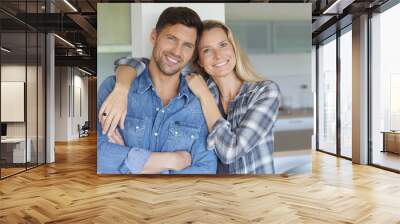 Portrait of cheerful middle-aged couple at home Wall mural