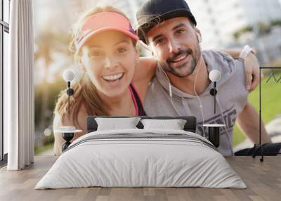 Portrait of couple of joggers exercising together Wall mural