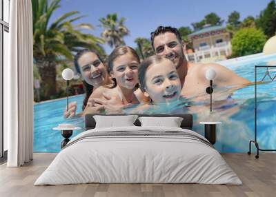 Portrait of happy family at the swimming-pool in summer Wall mural