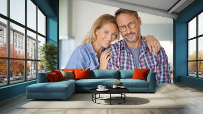 Portrait of mature couple standing in home kitchen Wall mural