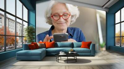 Portrait of senior woman using smartphone Wall mural