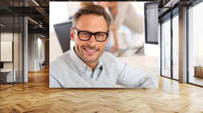 Portrait of smiling businessman with eyeglasses Wall mural