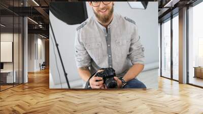 Portrait of young photographer working in studio Wall mural