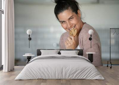 Pregnant woman eating cookies Wall mural