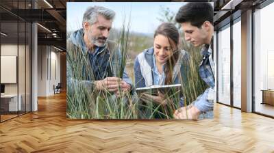 Teacher with students in agronomy looking at vegetation Wall mural