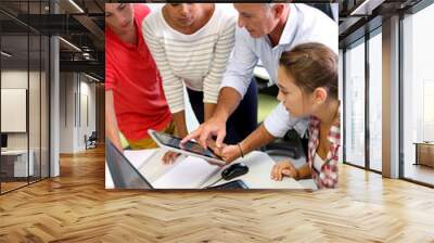 Teacher with students in computing class Wall mural