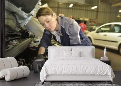 Technician woman working in auto repair workshop Wall mural