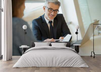 Woman in banker's office signing financial loan for project Wall mural