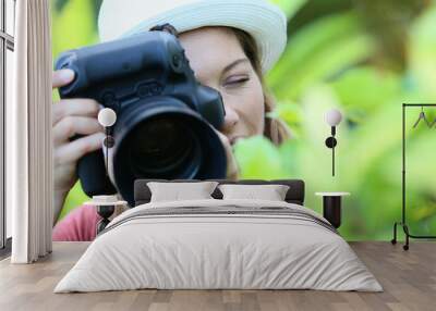 Woman photographer taking picture of nature Wall mural