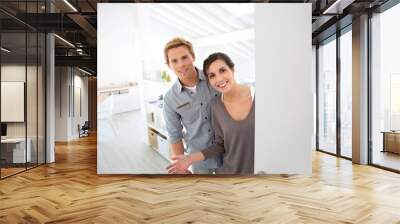 Young couple inviting people to come in new place Wall mural