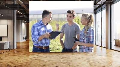 young people with instructor in agricultural field Wall mural