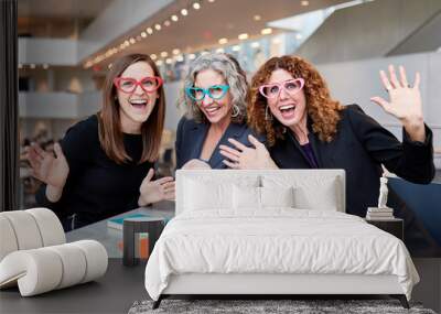 three business women having a meeting and wearing heart shaped glasses Wall mural