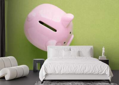 piggy bank concept isolated on green background Wall mural