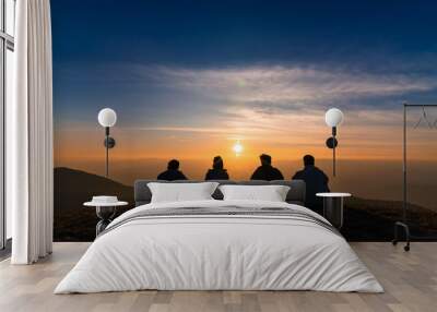 silhouette of friends  sitting together watching sunset for business successful and team work concept Wall mural