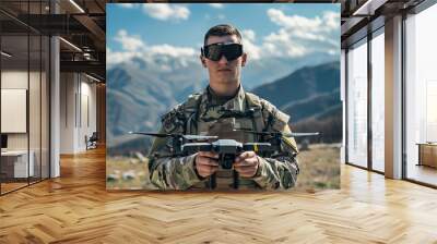 Natural candid shot of FPV drone pilot soldier with drone wearing military army clothes. Isolated against mountain background, sunny, bright, blue sky Wall mural