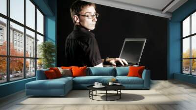 man on black background peers into computer Wall mural