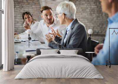 Businessman arguing with his colleague on a meeting in the office. Wall mural