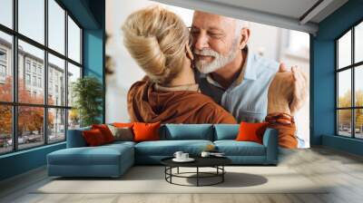 Close up of a happy mature couple having fun while dancing at home Wall mural