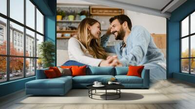 Loving happy couple talking to each other at home Wall mural