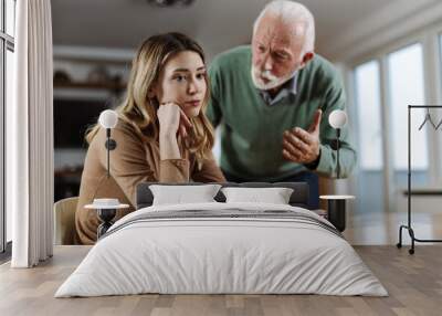 Mature father arguing with his adult daughter at home Wall mural