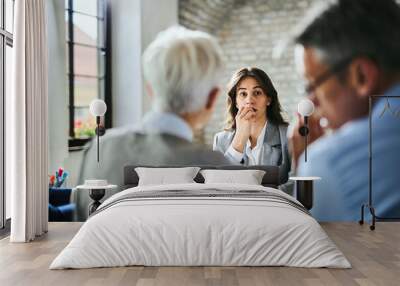 Worried businesswoman waiting for human resource's decision on a job interview.  Wall mural