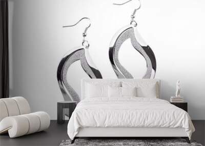 Pair of silver earrings isolated on white background Wall mural