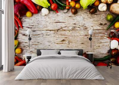 Frame of various vegetables over a rustic wooden background with Wall mural