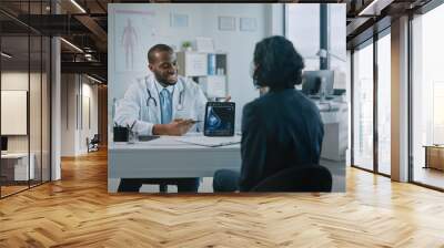 African American Medical Doctor Showing Mammography Test Results to a Patient on a Tablet Computer in a Health Clinic. Friendly Assistant Explains Importance of Breast Cancer Prevention Screening. Wall mural