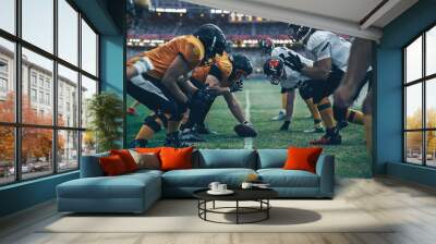 American Football Championship. Teams Ready: Professional Players, Aggressive Face-off, Ready for Pushing, Tackling. Competition Full of Brutal Energy, Power. Stadium Shot with Dramatic Light Wall mural