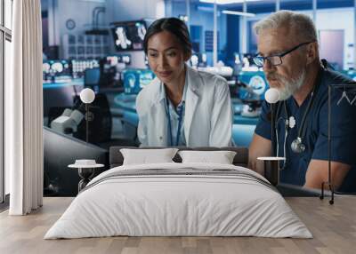 Asian Female Scientist Using Desktop Computer And Talking To Caucasian Male Doctor In Medical Hospital Research Lab. Colleagues Discussing Test Results Of Patients, Treatment Methods, Medication. Wall mural