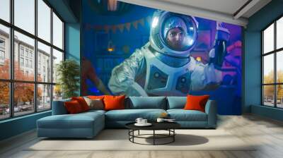 At the College House Costume Party: Fun Guy Wearing Space Suit Dances Off, Doing Robot Dance Modern Moves. With Him Beautiful Girls and Boys Dancing in Neon Lights. Wall mural