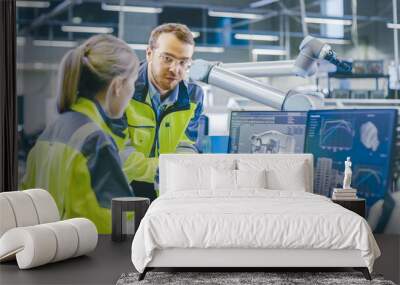 At the Factory: Male Mechanical Engineer Holds Component and Female Chief Engineer Work on Personal Computer, They Discuss Details of the 3D Engine Model Design for Robotic Arm. Wall mural