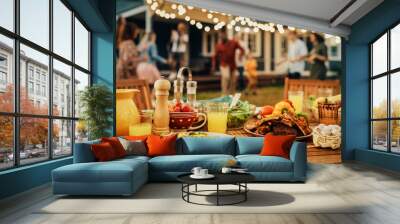 Backyard Dinner Table with Tasty Grilled Barbecue Meat, Fresh Vegetables and Salads. Happy Joyful People Dancing to Music, Celebrating and Having Fun in the Background on House Porch. Wall mural