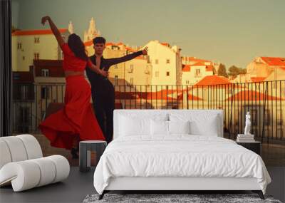 Beautiful Couple Dancing a Latin Dance Outside the City with Old Town in the Background. Sensual Dance by Two Professional Dancers on a Sunset in Ancient Culturally Rich Tourist Location. Wall mural