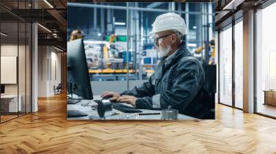 Car Factory Office: Portrait of Male Engineer Wearing Safety Hard Hat Working on Computer. Techniciancian Constructing Component. Automated Robot Arm Assembly Line Manufacturing Electric Vehicles Wall mural