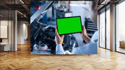 Car Service Manager or Mechanic Uses a Tablet Computer with a Green Screen Mock Up that is Pointed at an Enginer Bay. Specialist Inspecting the Vehicle in Order to Find Broken Components In the Engine Wall mural